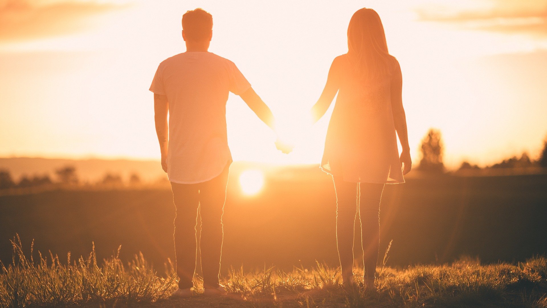 A person standing in front of a sunset